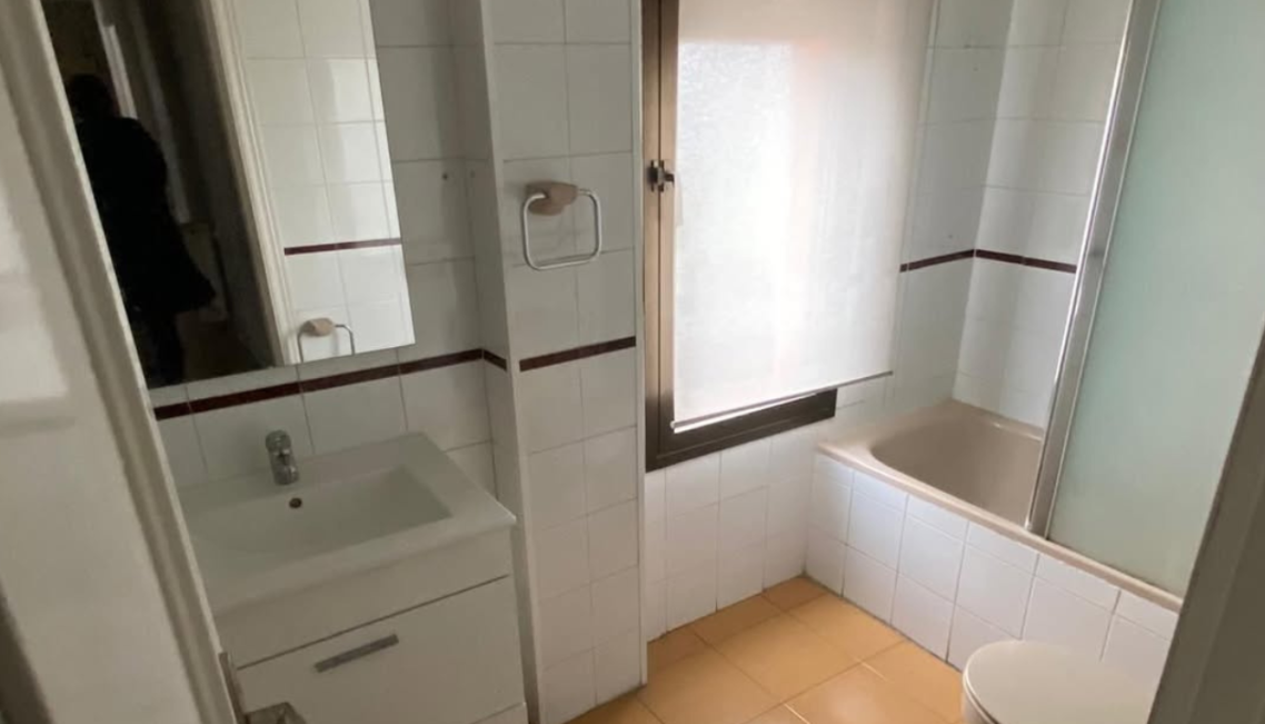 Interior moderno con mesa, sillas, y decoración en microcemento claro mate.